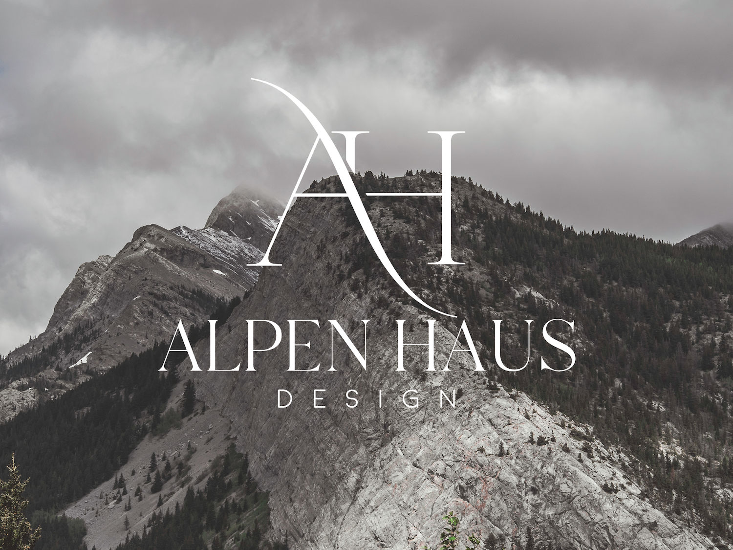 Mountain landscape with 'Alpen Haus Design' logo overlay